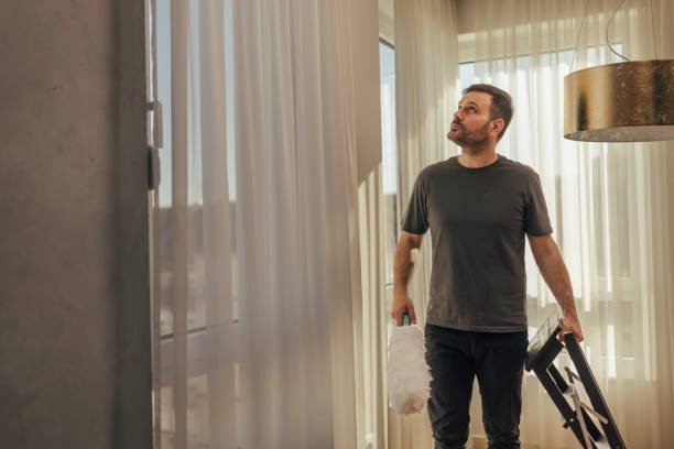 imgi_62_man-with-vacuum-cleaner-in-sunny-room